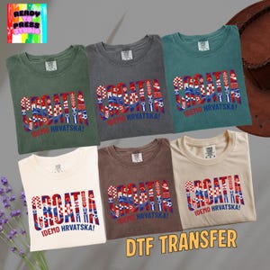 May include: Six t-shirts in various colors, including green, gray, and white, are displayed. Each shirt features the word "CROATIA" in a patriotic design with the text "IDEMO HRVATSKA!" below. The image also includes the text "DTF TRANSFER".