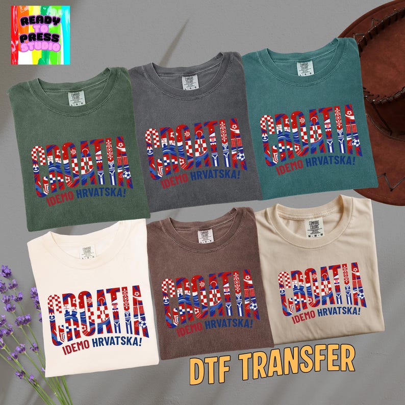 May include: Six t-shirts in various colors, including green, gray, and white, are displayed. Each shirt features the word "CROATIA" in a patriotic design with the text "IDEMO HRVATSKA!" below. The image also includes the text "DTF TRANSFER".