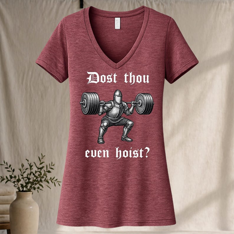May include: Maroon V-neck t-shirt with the text "Dost thou even hoist?" above a graphic of a knight lifting a barbell. The graphic is in black and white.