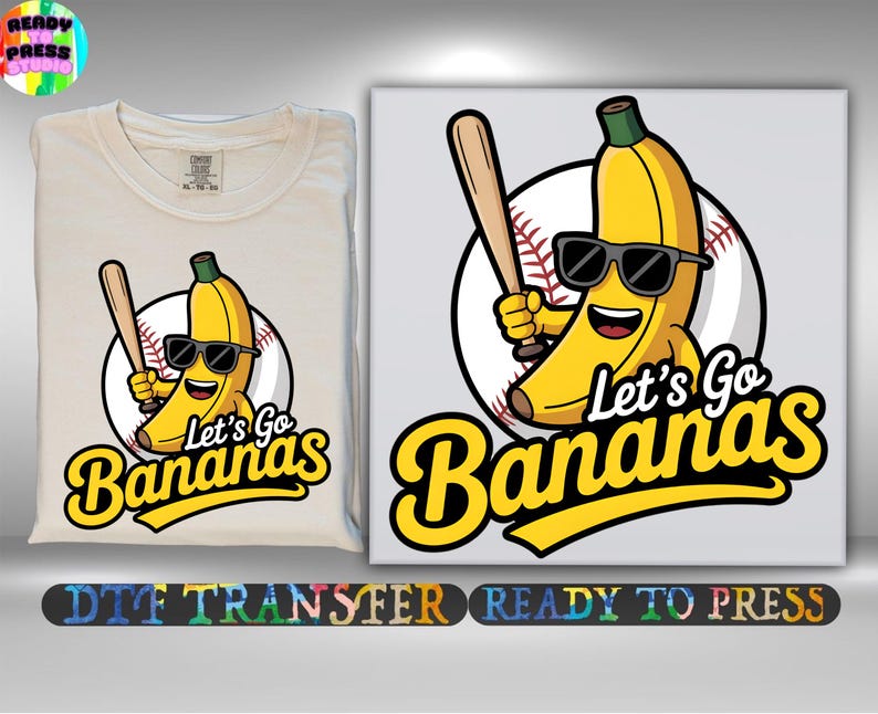 May include: A cream-colored t-shirt and a canvas print featuring a cartoon banana wearing sunglasses and holding a baseball bat. The text "Let's Go Bananas" is in yellow script. The image is a DTF transfer.