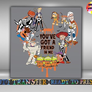 May include: A gray graphic featuring characters from the Toy Story franchise in Halloween costumes. The image includes a dinosaur, Woody, Jessie, and others, all in skeleton or mummy costumes. The text "YOU'VE GOT A FRIEND IN ME" is also included.