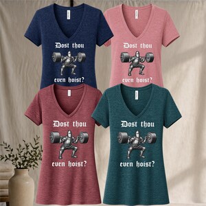 May include: Four V-neck t-shirts in navy, pink, burgundy, and teal. Each shirt features a graphic of a knight lifting weights with the text "Dost thou even hoist?" in white. The shirts are made of a soft material.
