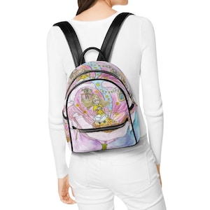 May include: A small backpack featuring a colorful illustration of a blonde character sitting inside a large pink flower. The bag has black straps, black trim, and a front zippered pocket. The design includes small yellow stars and blue accents.