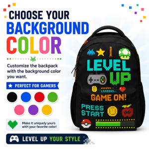 May include: A black backpack featuring colorful pixel art graphics including a game controller, a heart, a coin, and the text "LEVEL UP", "GAME ON!", and "PRESS START". The design includes a loading bar and various gaming icons in a retro style.