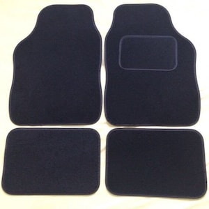 May include: Set of four dark blue car floor mats. The mats are made of a soft, plush material and have a simple, rectangular shape.