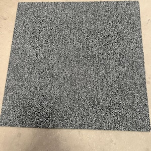 May include: A close-up of a dark grey carpet tile with a subtle speckled pattern.