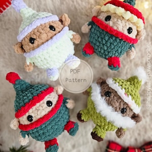 May include: Four handmade crochet elf dolls in various colors. Each doll has a round body, small arms and legs, and a pointed hat. The dolls are in shades of green, red, white, and light blue. The text "PDF Pattern" is in the center.