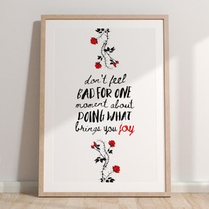 May include: A black and white printable art print with a quote that reads "don't feel bad for one moment about doing what brings you joy". The quote is surrounded by a black silhouette of a rose bush with red roses.