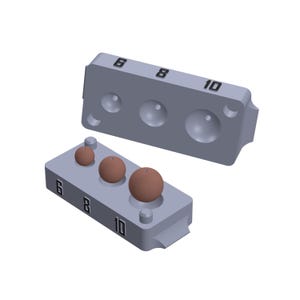May include: A gray plastic mold with three round depressions, labeled 6, 8, and 10. Three brown spheres are sitting in the depressions.