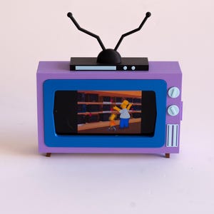 Soporte para teléfono estilo retro de Los Simpson – Regalo divertido para él – Base para teléfono con diseño de dibujos animados – Colores personalizados disponibles
