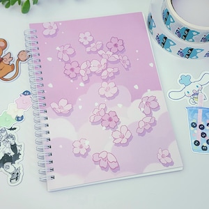 Sakura Clouds Reusable Sticker Book | Silicone coated, double-sided blank 50 page spiral notebook with pink cherry blossom design. A5 size