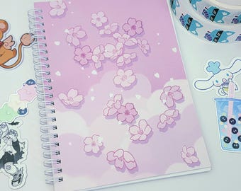 Sakura Clouds Reusable Sticker Book | Silicone coated, double-sided blank 50 page spiral notebook with pink cherry blossom design. A5 size