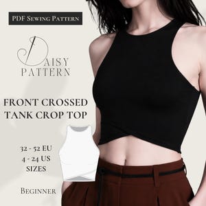 May include: A black front-crossed tank crop top. The image includes the text "PDF Sewing Pattern", "Daisy Pattern", "Front Crossed Tank Crop Top", "32-52 EU, 4-24 US Sizes", and "Beginner". The tank top is worn with brown pants.