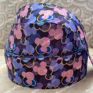 May include: Purple, pink, and blue patterned ribbon with gold outlines of Mickey Mouse heads. The ribbon is on a white background.
