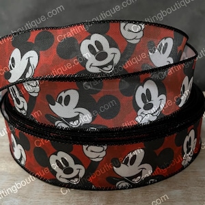 May include: Red and black ribbon with a repeating pattern of Mickey Mouse heads. The ribbon has a black border.