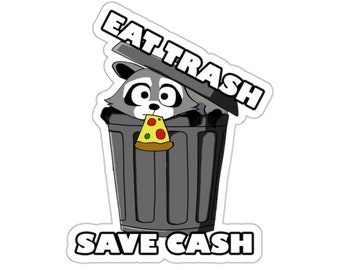 May include: A sticker featuring a cartoon raccoon inside a gray trash can, holding a slice of pizza. The text "EAT TRASH" is above the trash can, and "SAVE CASH" is below.