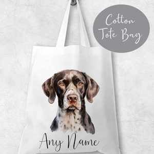 May include: White cotton tote bag featuring a watercolour illustration of a brown and white German Shorthaired Pointer dog. The text "Any Name" is printed below the dog.
