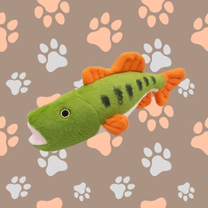 May include: A green and orange plush fish toy with a realistic design. The fish has a wide open mouth and a black eye. The toy is perfect for dogs to play with and chew on.