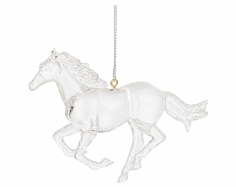 May include: A clear, transparent horse ornament in a galloping pose, featuring a detailed mane and tail. The horse is suspended by a thin silver-toned chain attached to a small gold-toned metal loop fixed to the top of the horse's back.