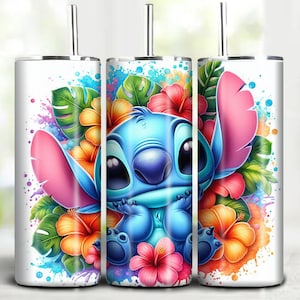 May include: A white tumbler featuring a blue cartoon character with large ears, surrounded by colorful flowers and tropical leaves. The design includes pink, orange, and red hibiscus flowers, with a splash of watercolor effects.