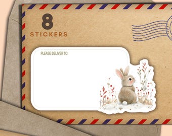 May include: A set of eight stickers featuring a watercolor illustration of a bunny in a snowy field. The stickers are on a brown envelope with red, white, and blue trim. The envelope has a blank address label and the text "PLEASE DELIVER TO:"