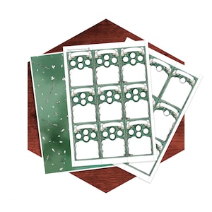 May include: A set of printed sheets featuring green decorative borders and blank rectangular spaces for writing. The design includes small circular frames and banner-like headers. One sheet displays a pattern of wands and stars on a green background.