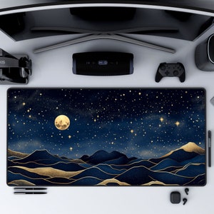 May include: A blue and gold mountain range desktop mouse pad with a full moon and stars in the night sky.