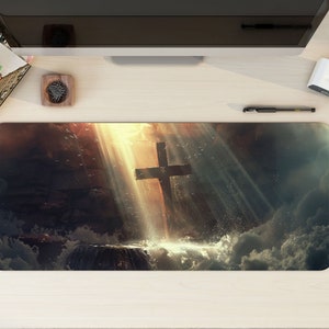 May include: A dark, dramatic image of a wooden cross standing in a body of water with light shining down from above. The cross is surrounded by clouds and the water is rippling.