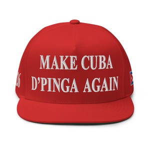 May include: A red flat-brimmed baseball cap with white embroidered text that reads "MAKE CUBA D'PINGA AGAIN." The cap has a small Cuban flag on the side and the number "26" on the other side.