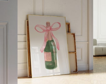 May include: A framed print of a watercolour illustration of a champagne bottle with a pink ribbon bow.