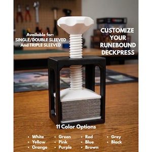 May include: A black and white deck press with a white screw and a stack of cards. The text reads "Customize Your Runebound Deckpress" and "11 Color Options". Available for single, double, and triple sleeved cards.