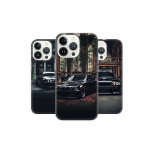 May include: Three black iPhone cases with a black car design. The cases feature a black car with red accents and a black background. The cases are all the same design but have different camera cutouts.