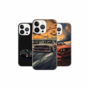 May include: Three iPhone cases with different designs featuring a black, red, and rusty orange car. The cases are all clear and show the phone's camera lenses.