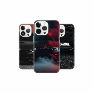 May include: Three phone cases with different designs featuring a black BMW car. The first case has a black car with red accents and smoke. The second case has a black car with blue headlights. The third case has a black car with a dark background.