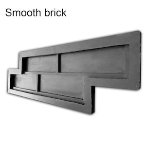 Puede incluir: Un molde de ladrillo gris oscuro con el texto "Smooth brick" en la parte superior. El molde es rectangular con un diseño escalonado, que presenta el contorno de varios ladrillos. El molde está diseñado para crear un patrón de ladrillo liso.