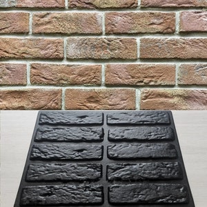 Puede incluir: Un molde de ladrillo negro para crear paneles de pared de ladrillo de hormigón. El molde está hecho de un material flexible y tiene una superficie texturizada.