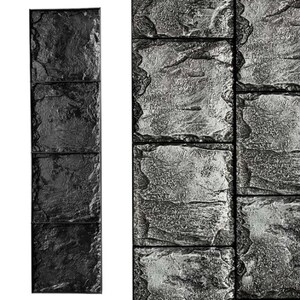 May include: A close-up of a black and gray stone-textured concrete mold. The mold is made up of four rectangular sections.