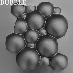 May include: A gray silicone mold with a bubble design. The mold is made of a flexible material and is perfect for making soap, candles, or other crafts.