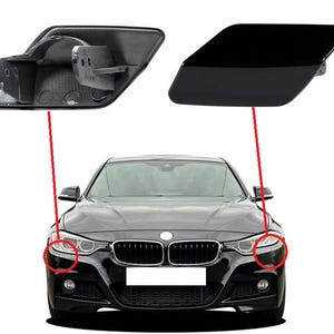 Op de afbeelding: Een zwarte auto met een zwarte voorbumper en koplampen. De auto heeft een zwarte grille met een zilveren embleem. De auto is scherp, de achtergrond is wazig.