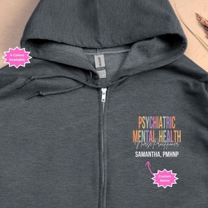 May include: Dark heather grey zip-up hoodie with a rainbow design that reads "Psychiatric Mental Health Nurse Practitioner" and "Samantha, PMHNP".