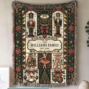 May include: A rectangular woven throw blanket featuring a Christmas theme with nutcrackers, a drum, a mouse king, a ballerina, ballet slippers, a rocking horse, a tree, and ornaments. The center text reads THE WILLIAMS FAMILY EST. 2014.