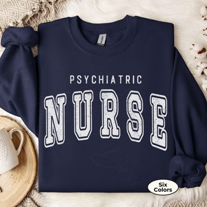 May include: Navy blue sweatshirt with the text "Psychiatric Nurse" in white with a distressed vintage look.
