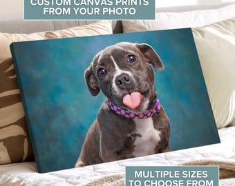 May include: Canvas print featuring a gray and white dog with its tongue sticking out. The dog wears a purple collar with white polka dots. Text on the canvas reads "CUSTOM CANVAS PRINTS FROM YOUR PHOTO" and "MULTIPLE SIZES TO CHOOSE FROM".