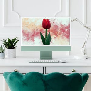 May include: A computer monitor with a green frame displays a digital illustration of a red tulip with green leaves on a background of pink and orange watercolour splatters.