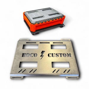 May include: An orange and gray storage container with a black base sits above a silver metal plate. The plate has cut-out rectangles and the words "BOCO CUSTOM" with a lightning bolt symbol.