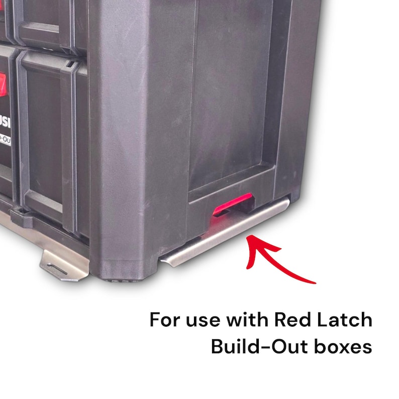 May include: A black plastic storage container featuring a metallic silver base plate with mounting tabs. A red arrow points toward the base, and the text below reads: For use with Red Latch Build-Out boxes. The container has a red latch visible.