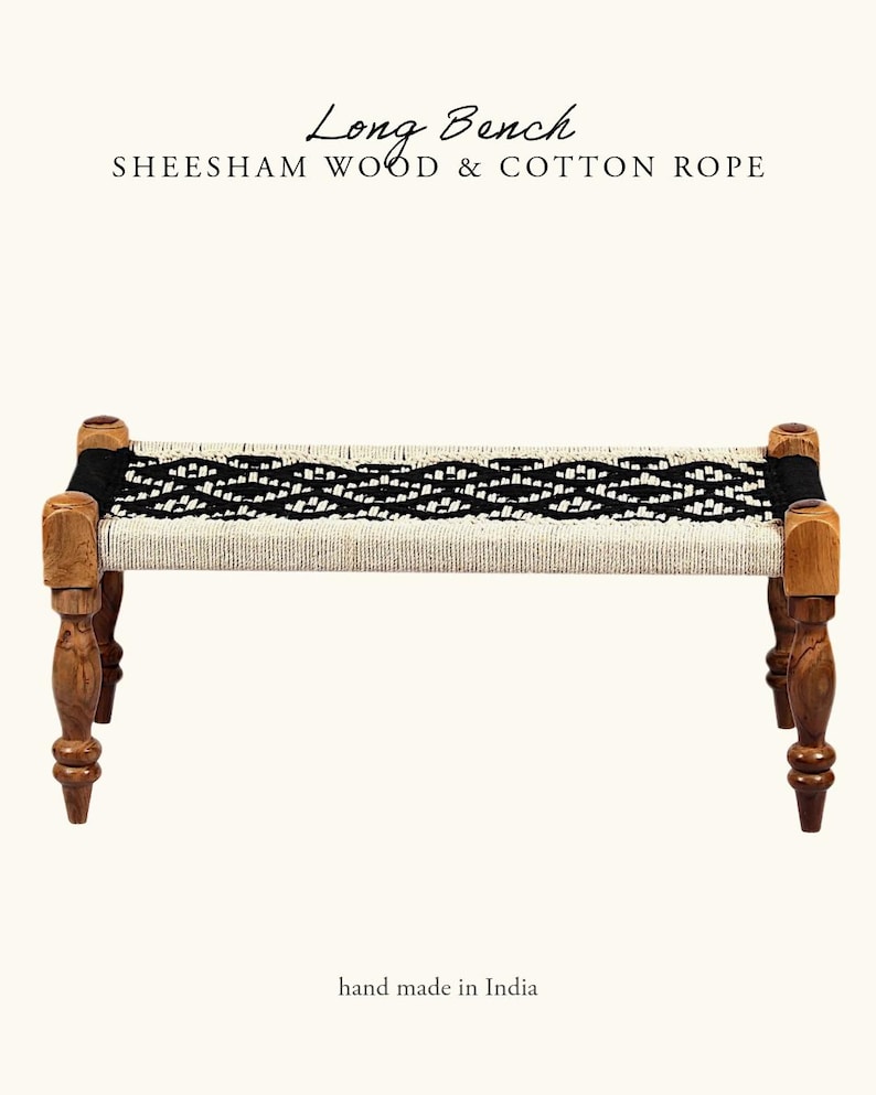 May include: A handcrafted long bench made of sheesham wood and cotton rope. The bench features a woven seat with black and white patterns, supported by four turned wooden legs. The text "Long Bench" and "hand made in India" are visible.