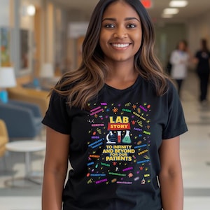 May include: A black t-shirt with the words "LAB STORY" in a colorful design. The shirt includes the text "TO INFINITY AND BEYOND FOR OUR PATIENTS" and various science-related terms and names. A woman is wearing the shirt.