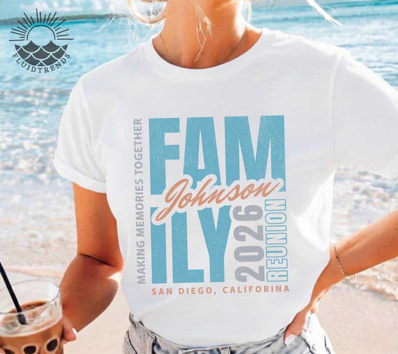 May include: White t-shirt featuring the word "FAMILY" in blue block letters, the name "Johnson" in a cursive font, and the year "2026" in grey. The shirt also says "REUNION" and "SAN DIEGO, CALIFORNIA".