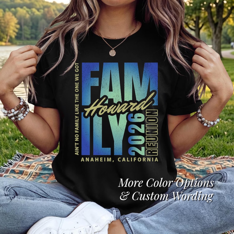 May include: Black t-shirt featuring a blue and green gradient "FAMILY" design. The text includes "Howard 2026 Reunion" and "Anaheim, California". Additional text at the bottom says "More Color Options & Custom Wording".